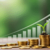 A vibrant, motivational image showing a seedling growing from a stack of coins, with a bright, upward-trending graph in the background. Description: Foreground: A small green seedling sprouting from a pile of gold coins, symbolizing money growing through smart investments. Background: A clean, modern graph or chart with an upward arrow, representing financial growth and success. Color Palette: Bright greens (growth), golds (wealth), and blues (trust and stability) to evoke positivity and confidence. Style: Clean, minimalist, and professional with a touch of warmth to appeal to a general audience.