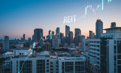A vibrant, high-resolution image of a modern city skyline with commercial buildings, symbolizing real estate wealth and opportunity. Include a subtle overlay of a stock market graph to represent REIT investments.